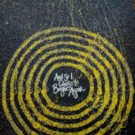 yellow and black round logo