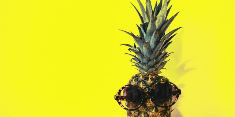 green-pineapple-fruit-with-brown-framed-sunglasses-beside-1161547