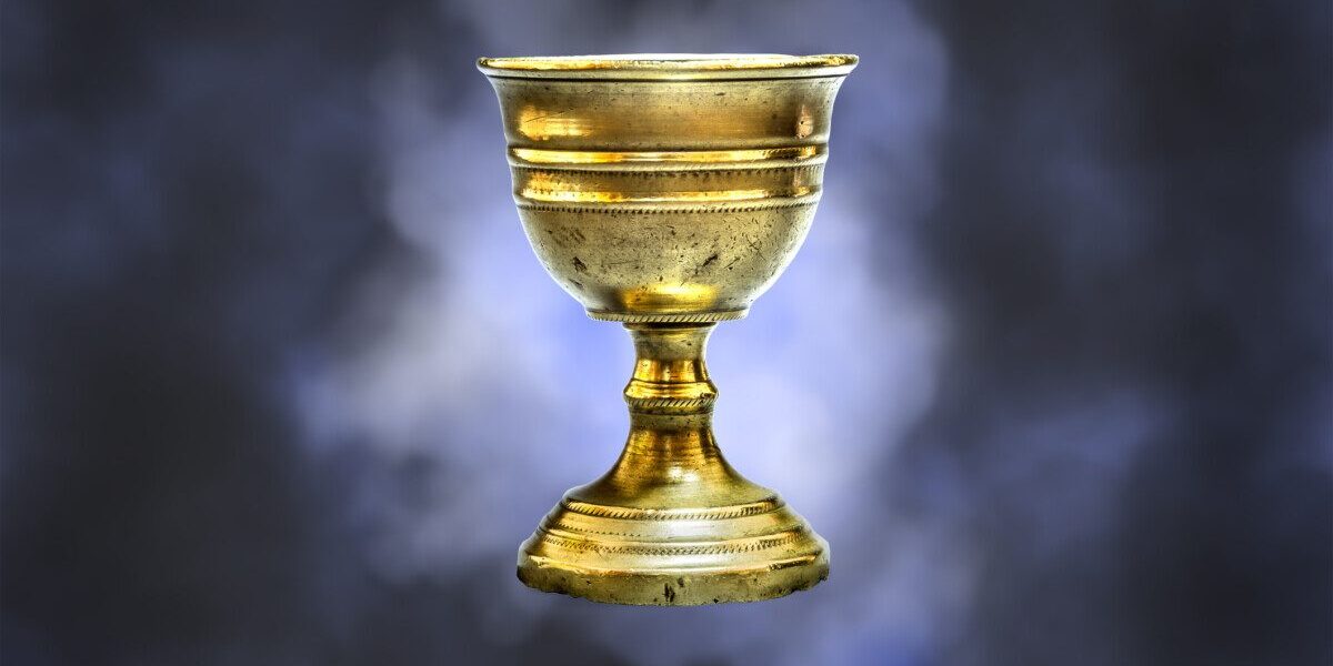 Old chalice on blue clouds background