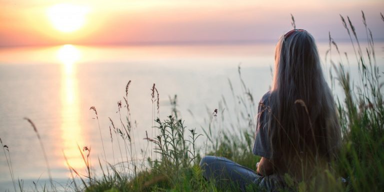 photo-of-woman-sitting-on-grass-during-golden-hour-4640845